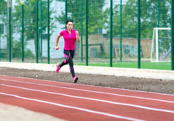 Fit healthy woman training on a race track