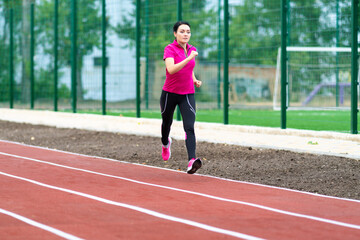 Fototapeta premium Woman runner training outdoors on a race track