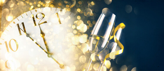 New year eve celebration with champagne flutes and midnight countdown  on golden firework bokeh...