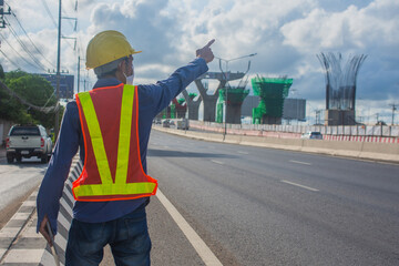 Engineer holding tablet working on site road construction
