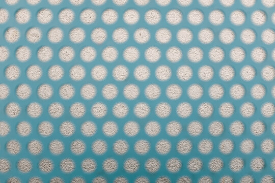 Detail of a patterned fence against a wall