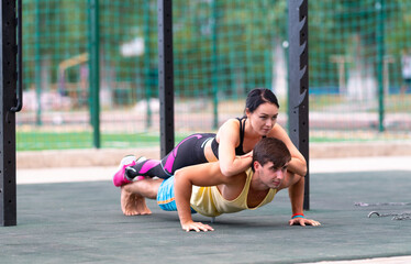 Fototapeta premium Strong fit young man doing push-ups outdoors