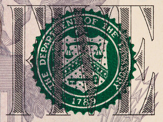 Five us dollar bill fragment with treasury seal macro, united states money closeup