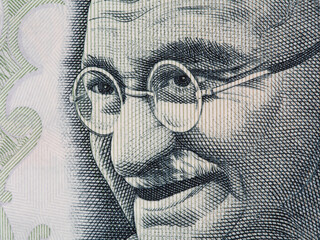 Mahatma Gandhi face on indian 100 rupee banknote extreme macro, India money closeup - obrazy, fototapety, plakaty