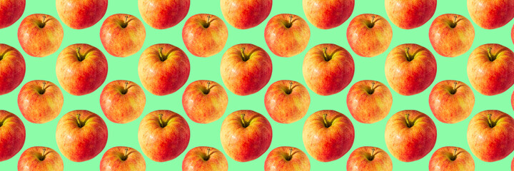 Banner-creative background of red apple. Abstract background. Isolated ripe Apples on green background not seamless pattern