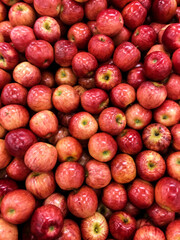 Red apples are on the shelves of the store