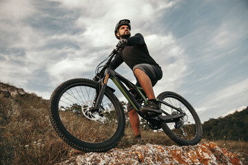 Fototapeta na wymiar Male cyclist riding bike in mountains