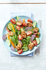 Healthy Salad with Chicken Breast, Cherry Tomatoes, Cucumber, Orange Pepper, Endive and Red Onion. Top view.