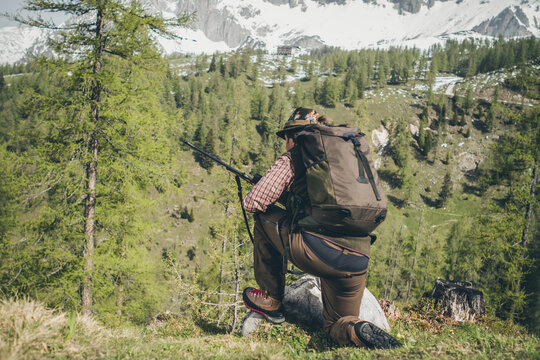 hunter with shotgun getting in shooting position