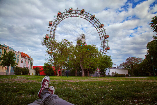 Woman lying on the grass in front of the Vienna Riesenrad