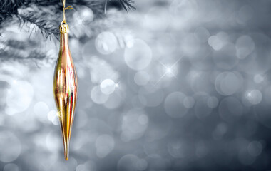 Golden Christmas icicle isolated on gray bokeh holiday light background