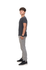 Naklejka premium full portrait of a teenage boy dressed in sportswear on white background, side view