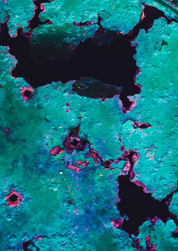 Abstract corrosive metal background with turquoise paint cracks