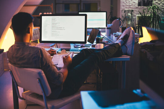 Programmer Working on a Computer Code at Night
