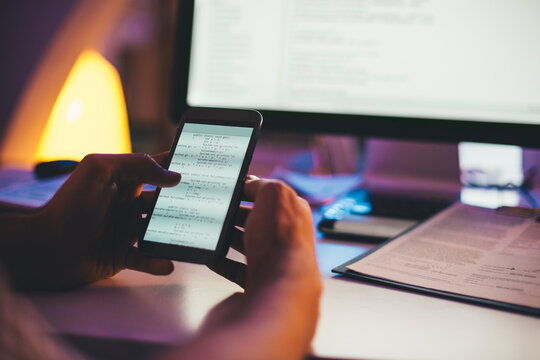 Programmer Looking at a Computer Code on a Smartphone