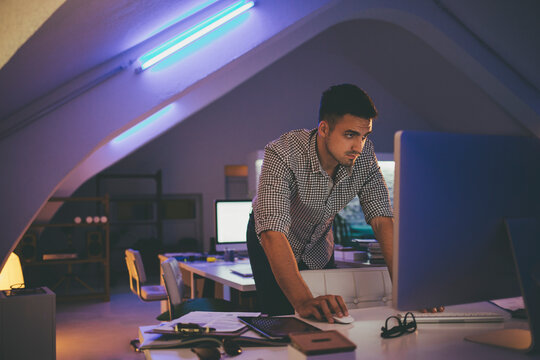 Caucasian Programmer Working at His Office at Night