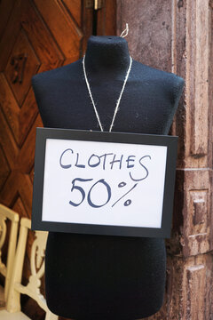 Fifty percent discount sign on a tailor's dummy