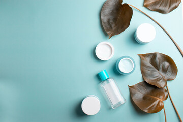 face cream or serum flacons on the mint background as eco friendly natural beauty industry concept