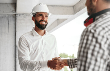 Contractor shaking hand of colleague