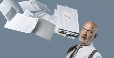 Paperwork hitting a businessman's head