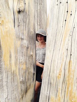 Girl hiding behind Sierra Juniper tree