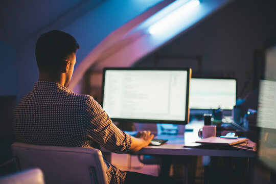 Programmer Writing a Computer Code at His Office at Night