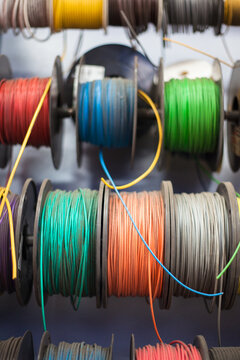 Spools of colorful electrical wire in a workshop