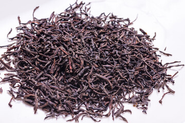 Fototapeta premium Dried black tea leaves, textured background