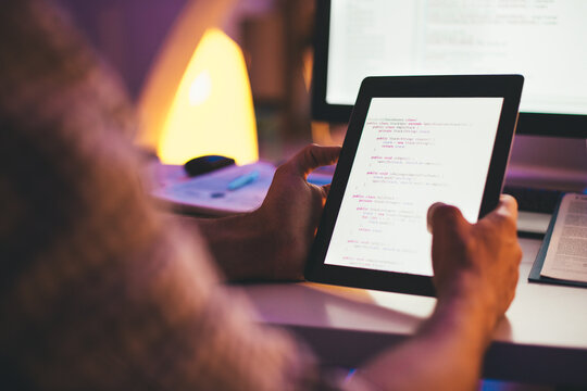 Programmer Checking a Computer Code on a Tablet