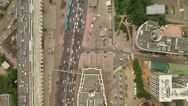 Road traffic in timelapse. People are going to work. Downtown. Cloudy weather.