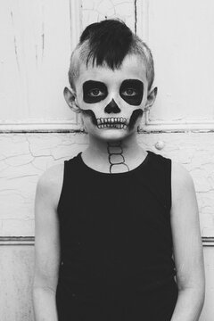 Portrait of a little boy with skeleton make up for halloween