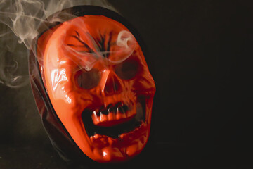 Scary Grim reaper face with red color, burning and smoke coming from eyes
