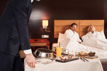 Couple ordering the service of breakfast in bed