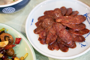 Close view of a set of sliced Sichuan sausages.