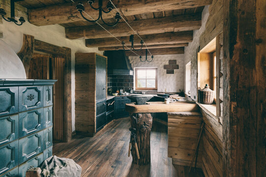 luxury open kitchen and livingroom inside a rustic austrian wooden alpine cabin