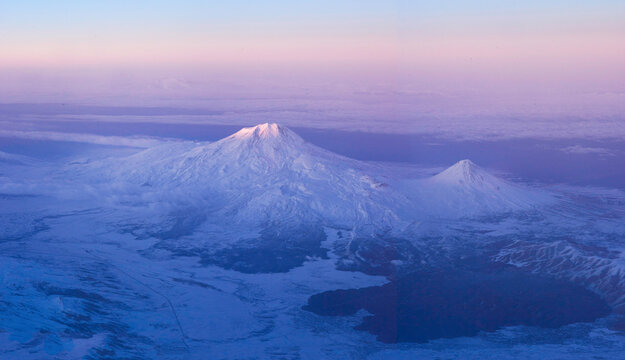 View through the window in an airplane. Sunset somewhere over Iran