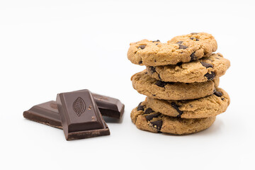 Some cookies and ounces of chocolate  in front of white background