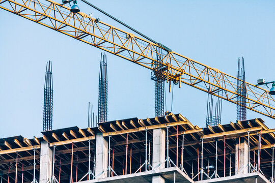 Construction site with yellow crane and building under construction