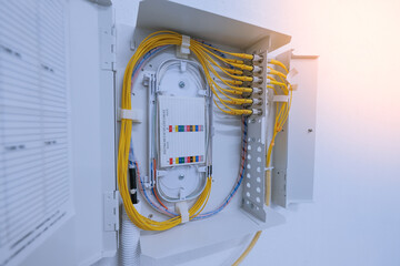 fiber optic cable connected to enclosure box in a technology data center room 