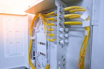 fiber optic cable connected to enclosure box in a technology data center room 