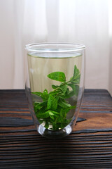 Herbal mint tea in thermo cup. Vertical background