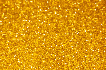 Golden abstract defocused bokeh background. Sparkling texture.
