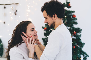 Happy couple embracing each other in living room