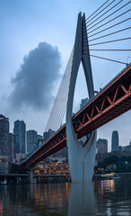 Night view of the Qiansimen bridge and the skyline in Chongqing, China.