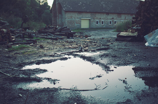 Old barn with pool after rain