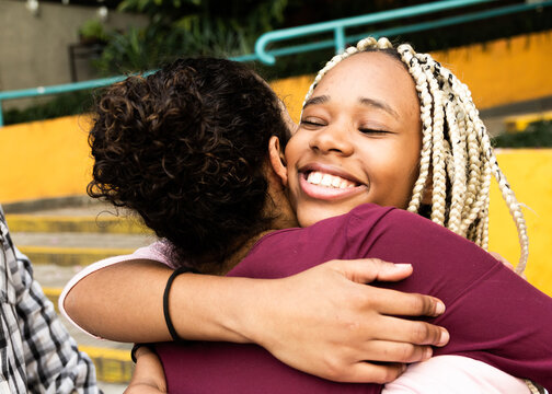 Happy person gives his friend a tight hug. Celebrations, reunions, meetings, friendship. Affection and union.