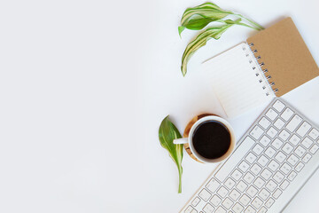 Office desk top view. Workspace with blank clip board, keyboard, office supplies, pencil, coffee cups on a white background. Place for text