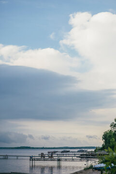 Dark Stormy Clouds with Silver Lining Over Calm Lake