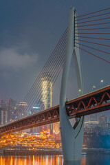 Naklejka premium Night view of the Qiansimen bridge and the skyline in Chongqing, China.