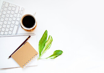 Office desk top view. Workspace with blank clip board, keyboard, office supplies, pencil, coffee cups on a white background. Place for text